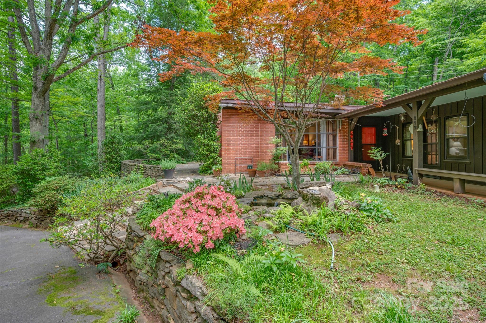 312 Page Farm Road Tryon, NC 28782 - Photo 5 of 44 a backyard of a house with lots of green space and fountain