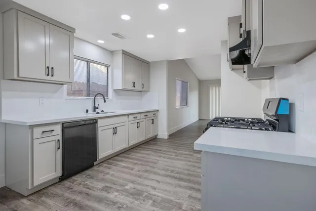 a kitchen with a sink stove and cabinets