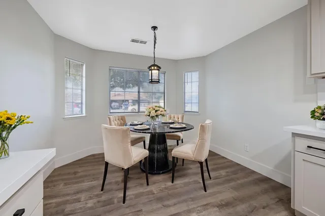 a view of a dining room with furniture window and wooden floor