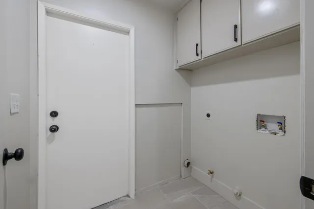 a view of a refrigerator and cabinets