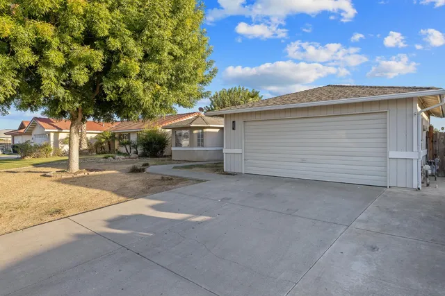 a backyard of a house with table and chairs