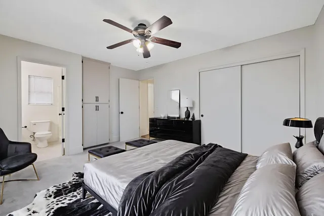 a bedroom with a large bed and a chandelier