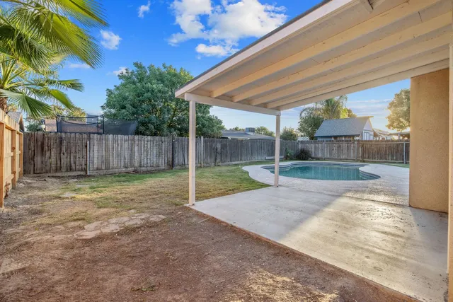 a view of a backyard with wooden fence