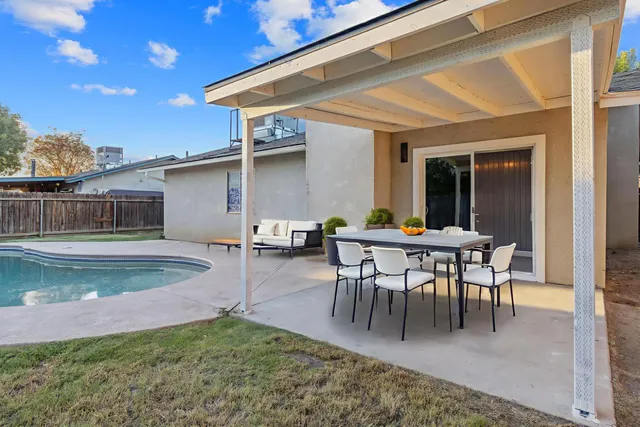 a view of a patio with table and chairs