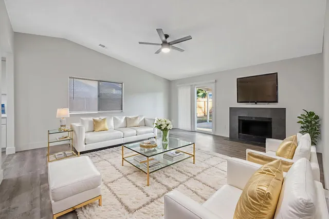 a living room with furniture a fireplace and a flat screen tv