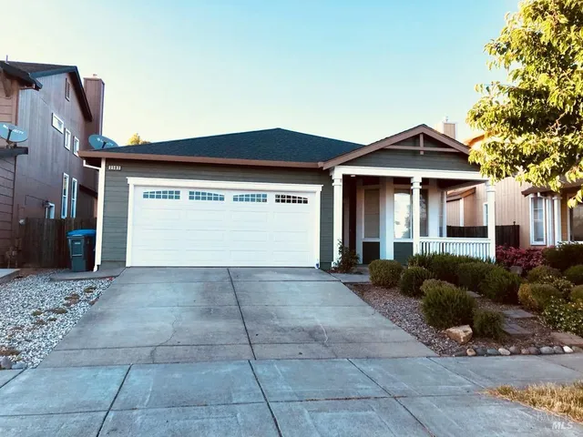 a view of a house with a yard and garage
