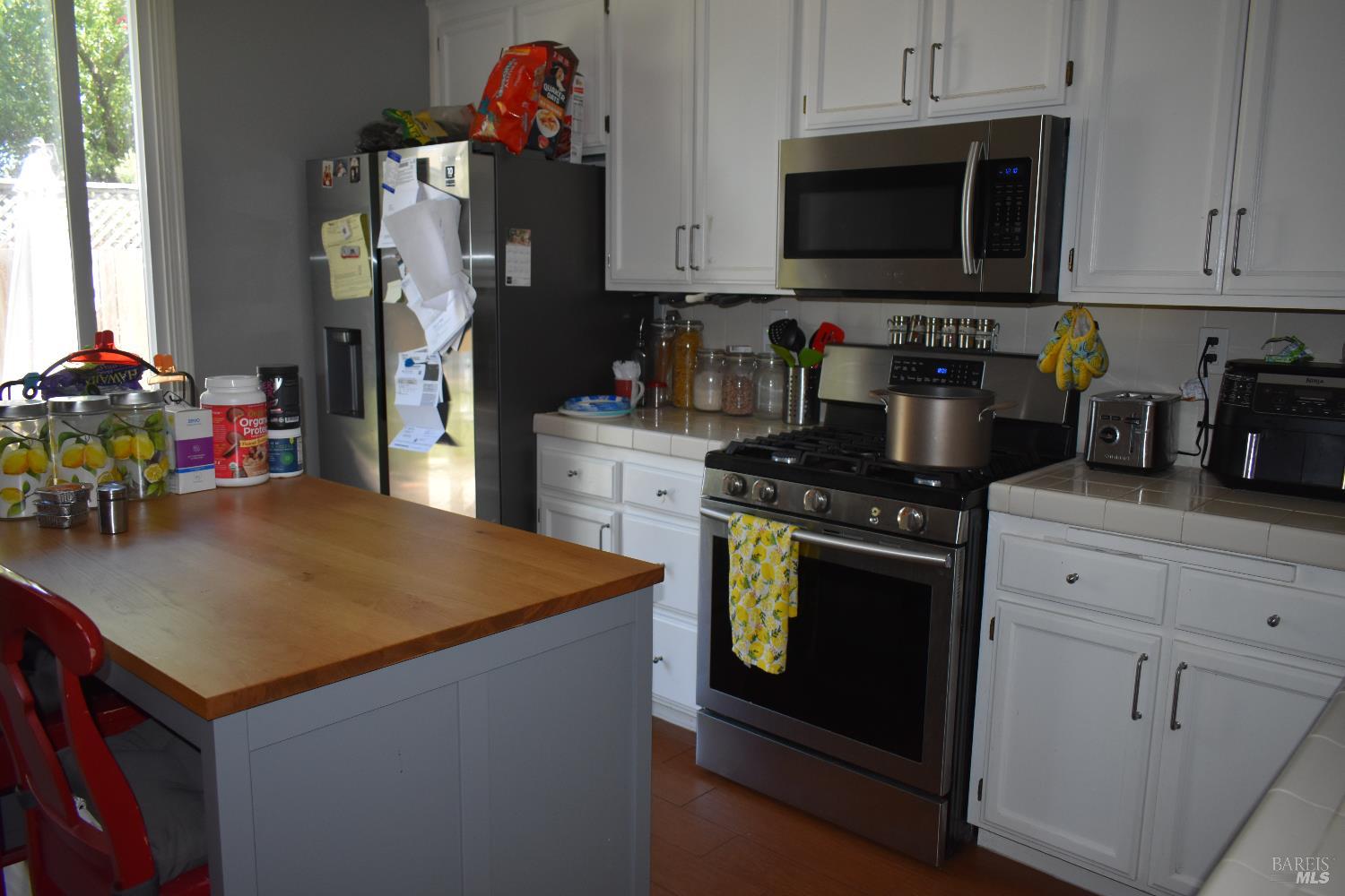 2507 Winterhaven Avenue Santa Rosa, CA 95404 - Photo 4 of 27 a kitchen with stainless steel appliances granite countertop a stove refrigerator and a microwave