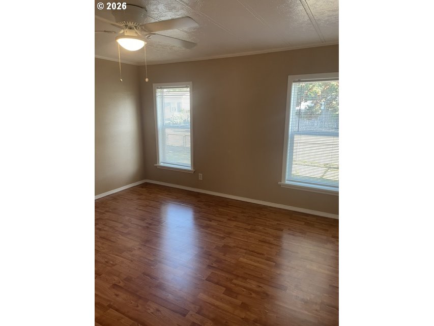 5660 Daisy Street, Unit 31 Springfield, OR 97478 - Photo 21 of 44 a view of an empty room with wooden floor and a window