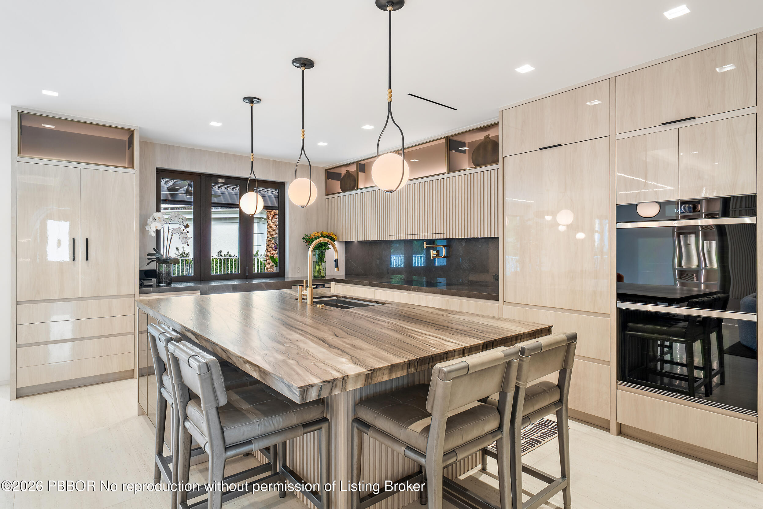 3501 Captains Way, Unit 3501 Jupiter, FL 33477 - Photo 9 of 41 a kitchen with stainless steel appliances granite countertop a stove a refrigerator a oven a kitchen island a dining table and chairs