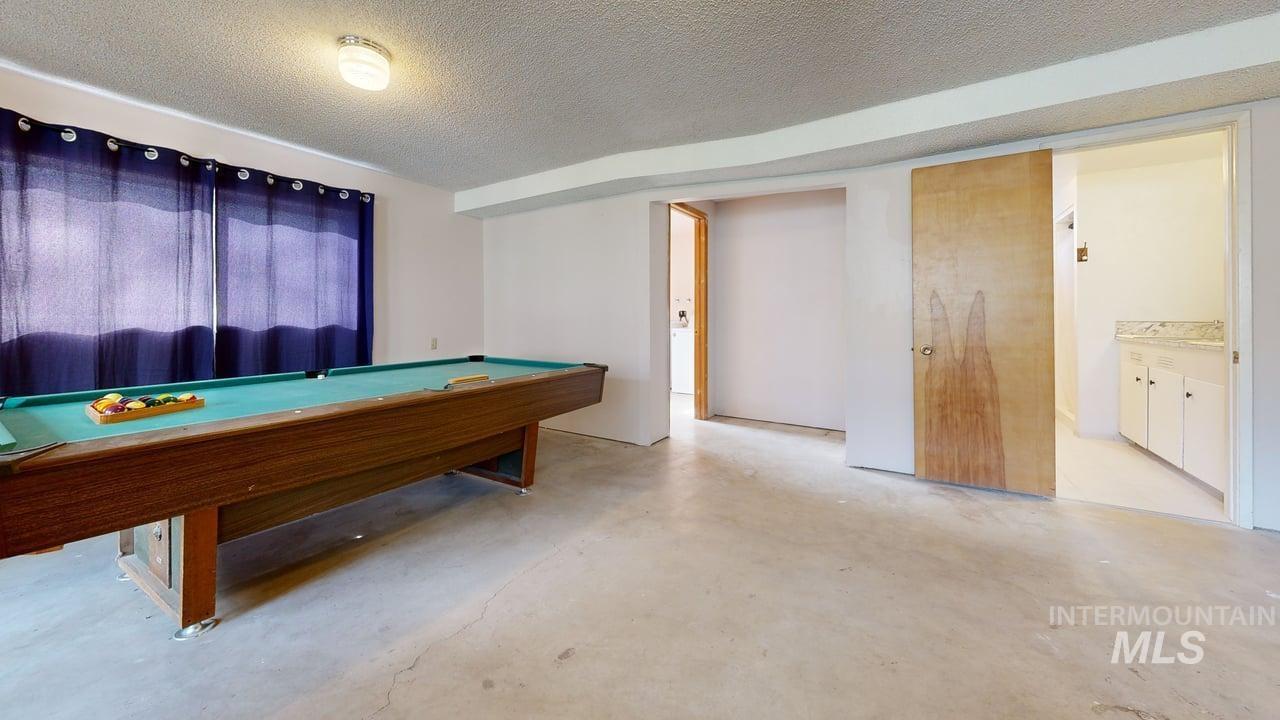 196 Main Street Juliaetta, ID 83535 - Photo 15 of 27 Recreation room with billiards table, a textured ceiling, and concrete floors