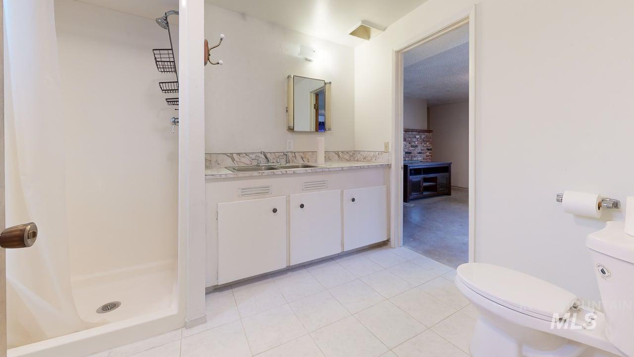 196 Main Street Juliaetta, ID 83535 - Photo 20 of 27 Bathroom featuring vanity, a shower stall, and light tile patterned floors
