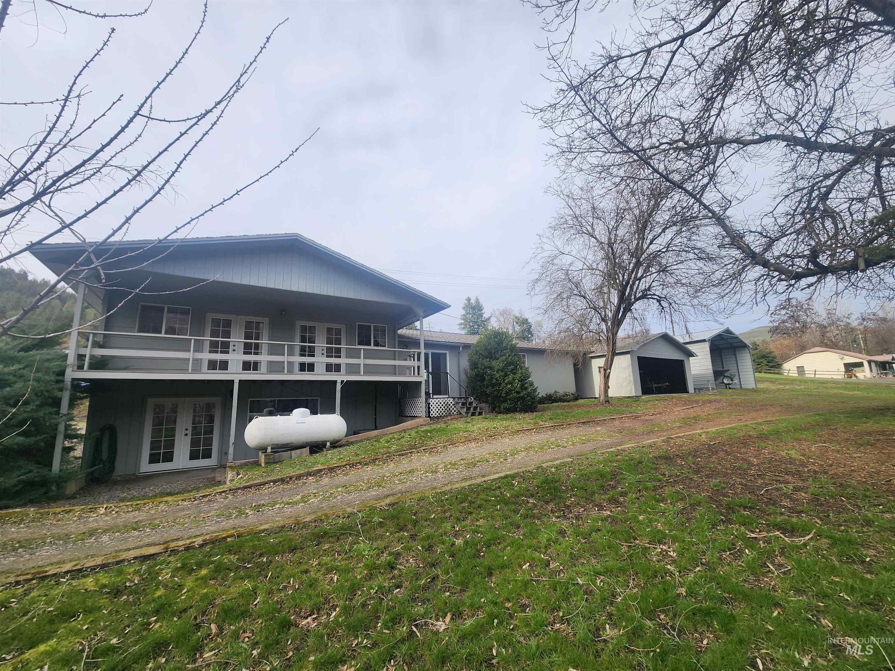 196 Main Street Juliaetta, ID 83535 - Photo 2 of 27 Back of property featuring a yard, an outbuilding, french doors, and a garage