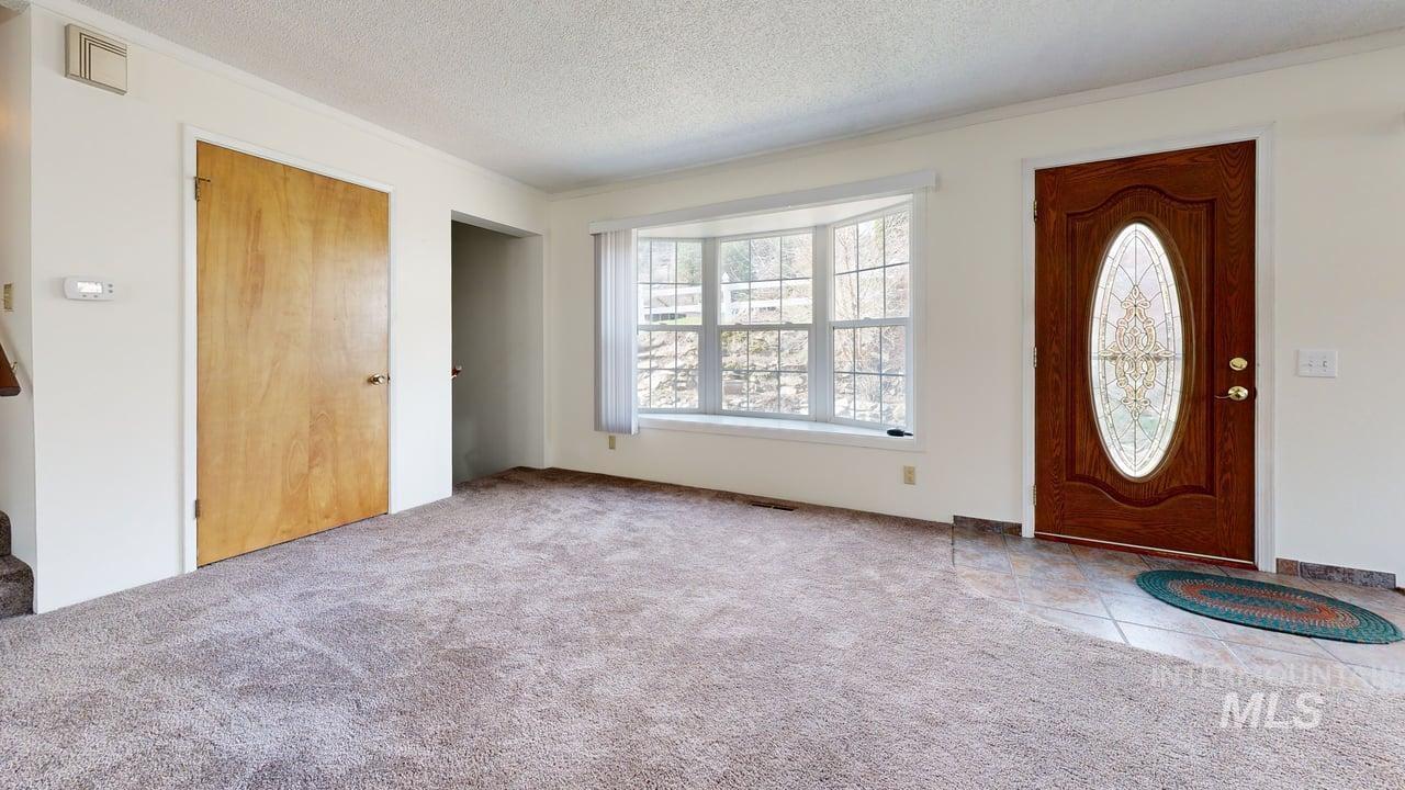 196 Main Street Juliaetta, ID 83535 - Photo 7 of 27 Carpeted foyer entrance with a textured ceiling