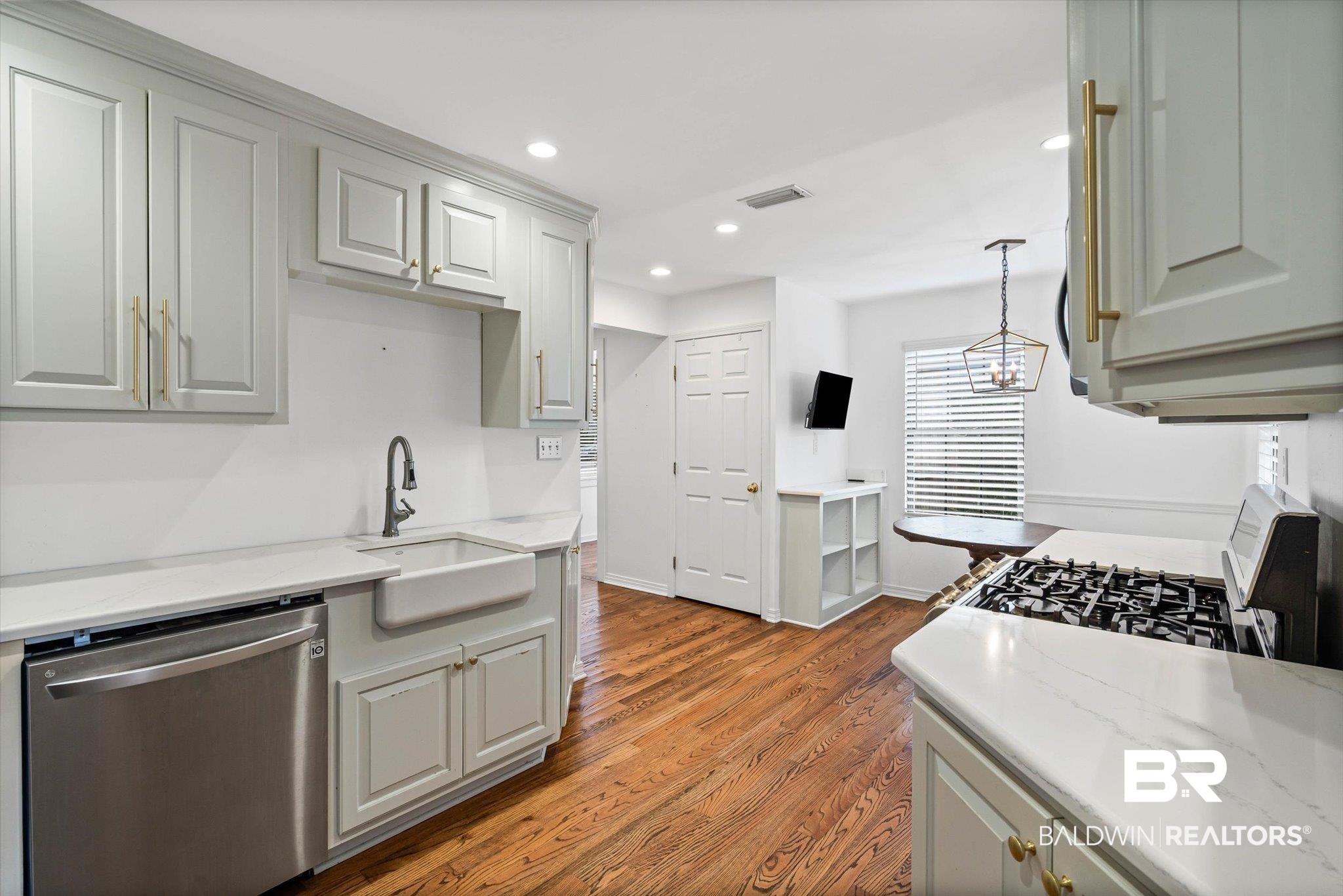 11 York Place Mobile, AL 36608 - Photo 9 of 24 Kitchen featuring appliances with stainless steel finishes, light stone counters, recessed lighting, dark wood-style flooring, and decorative light fixtures
