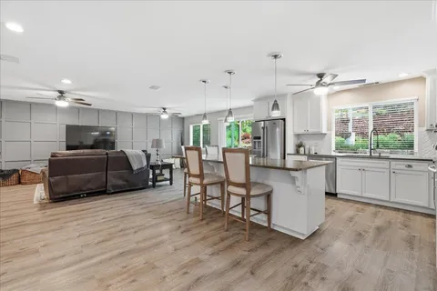 a view of a dining room with furniture and wooden floor