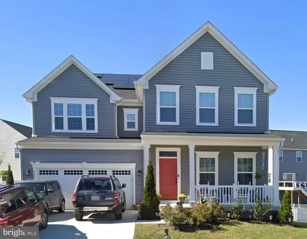 a view of a brick house with many windows and yard