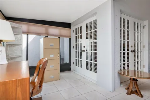 a view of a hallway with furniture and a large window