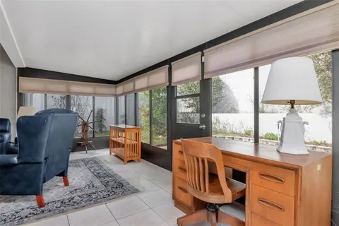 a living room with furniture and large windows