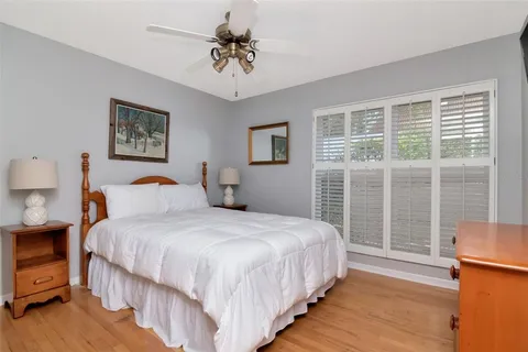 a bedroom with a large bed and a tv