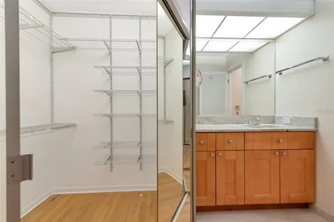 a bathroom with a granite countertop sink a mirror and shower