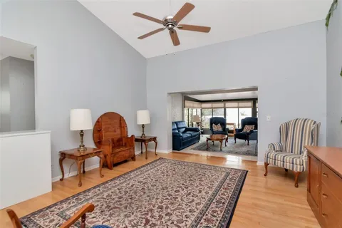 a living room with furniture a rug and white walls