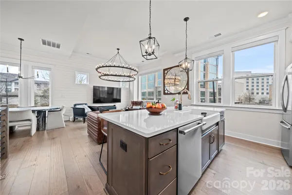 a kitchen that has a stove a table and chairs in it
