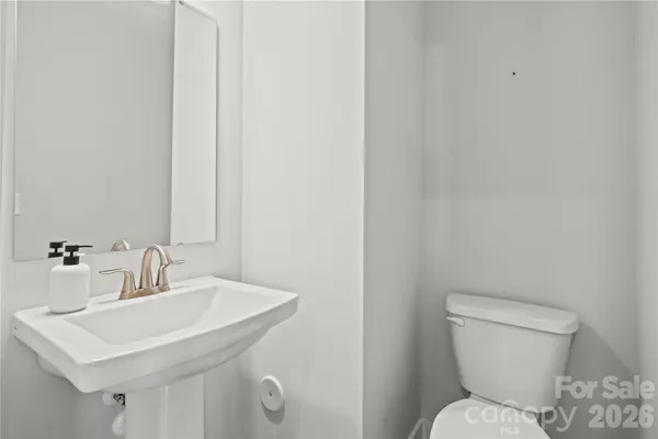 a bathroom with a toilet a sink and a mirror