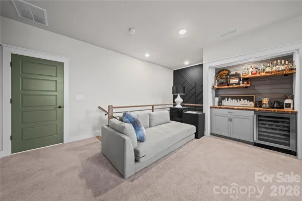 a living room with furniture and kitchen