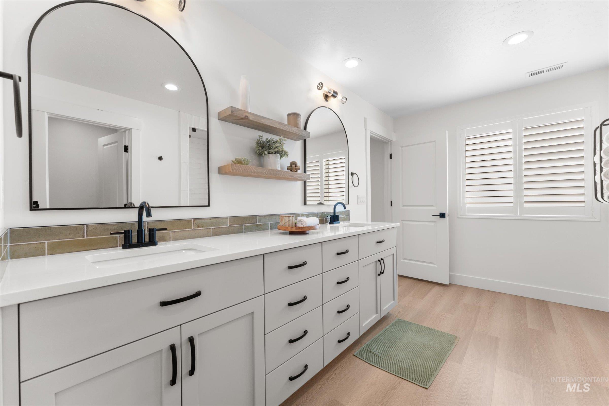 2172 Savoy Court Middleton, ID 83644 - Photo 20 of 46 Dedicated laundry space featuring wood-finish flooring and a window with blinds
