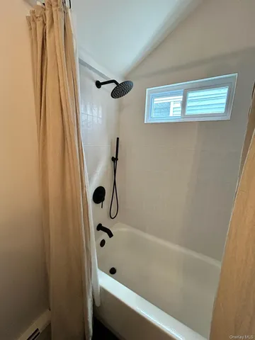 a bathroom with a tub and a shower