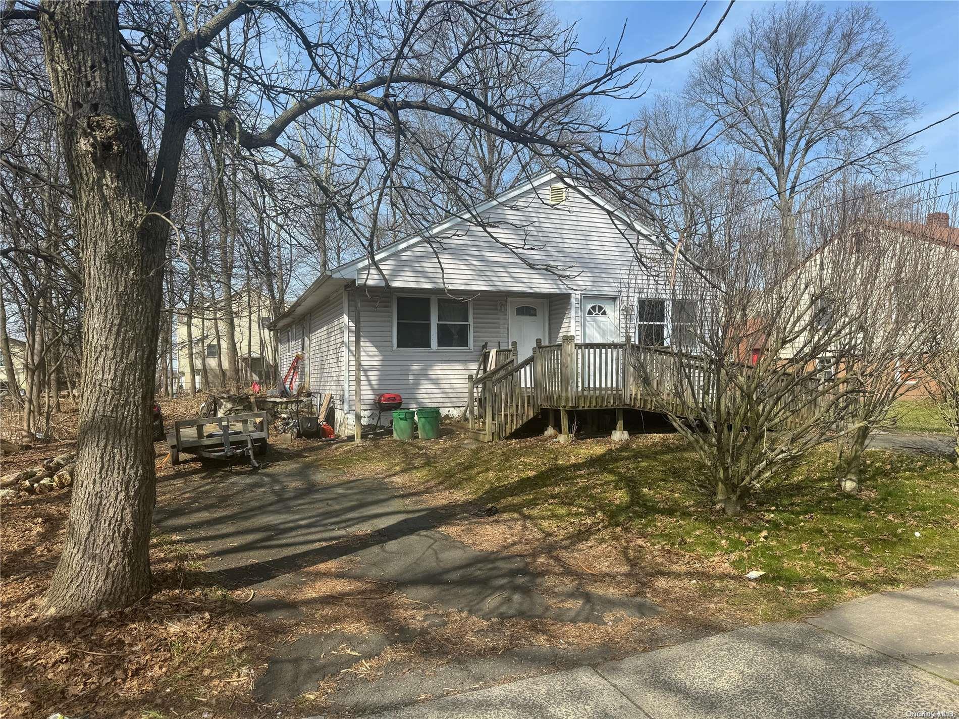 a view of a house with a yard covered in snow