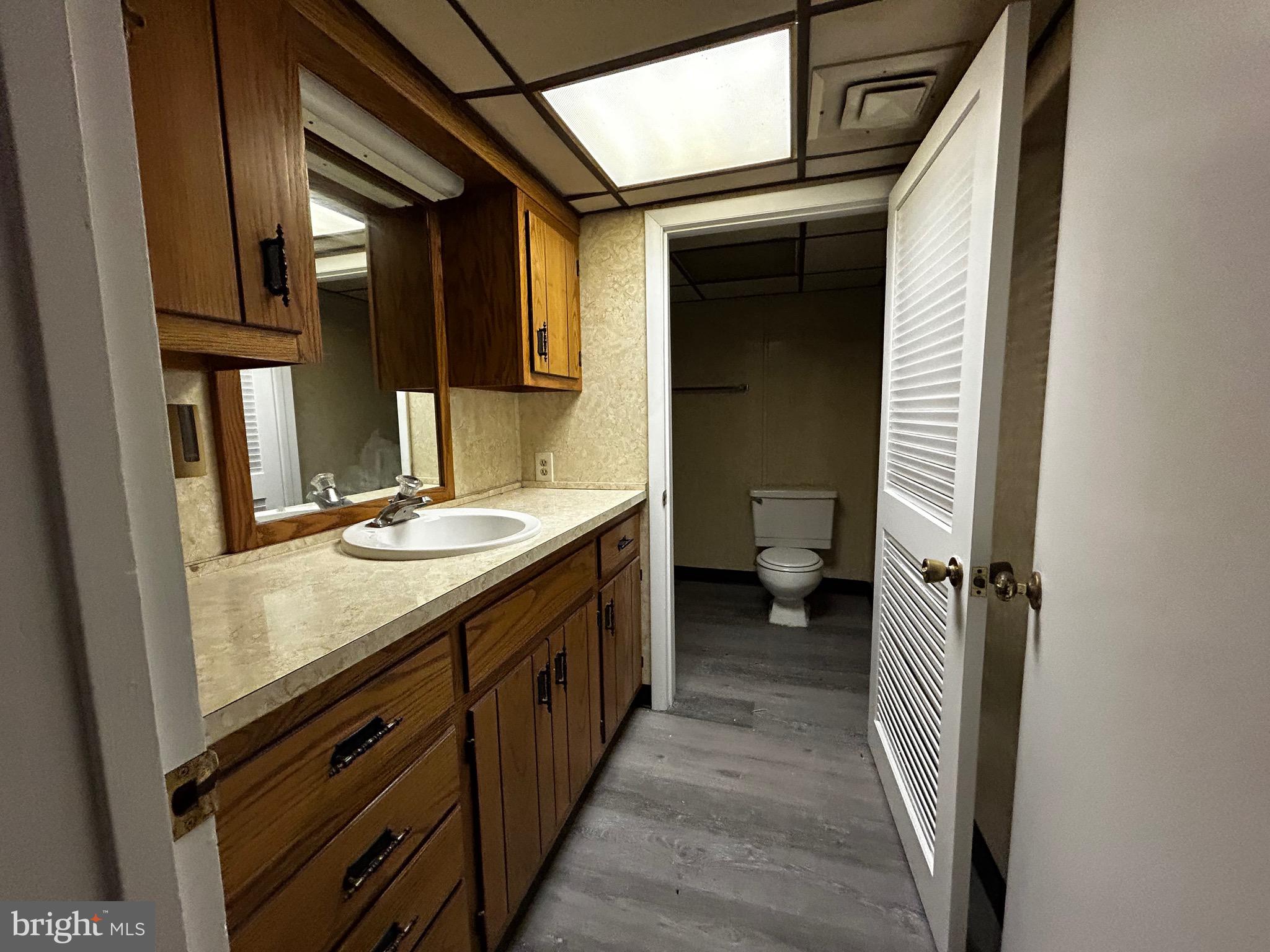762 East High Street, Unit 3 Pottstown, PA 19464 - Photo 13 of 19 a bathroom with a granite countertop sink and a mirror