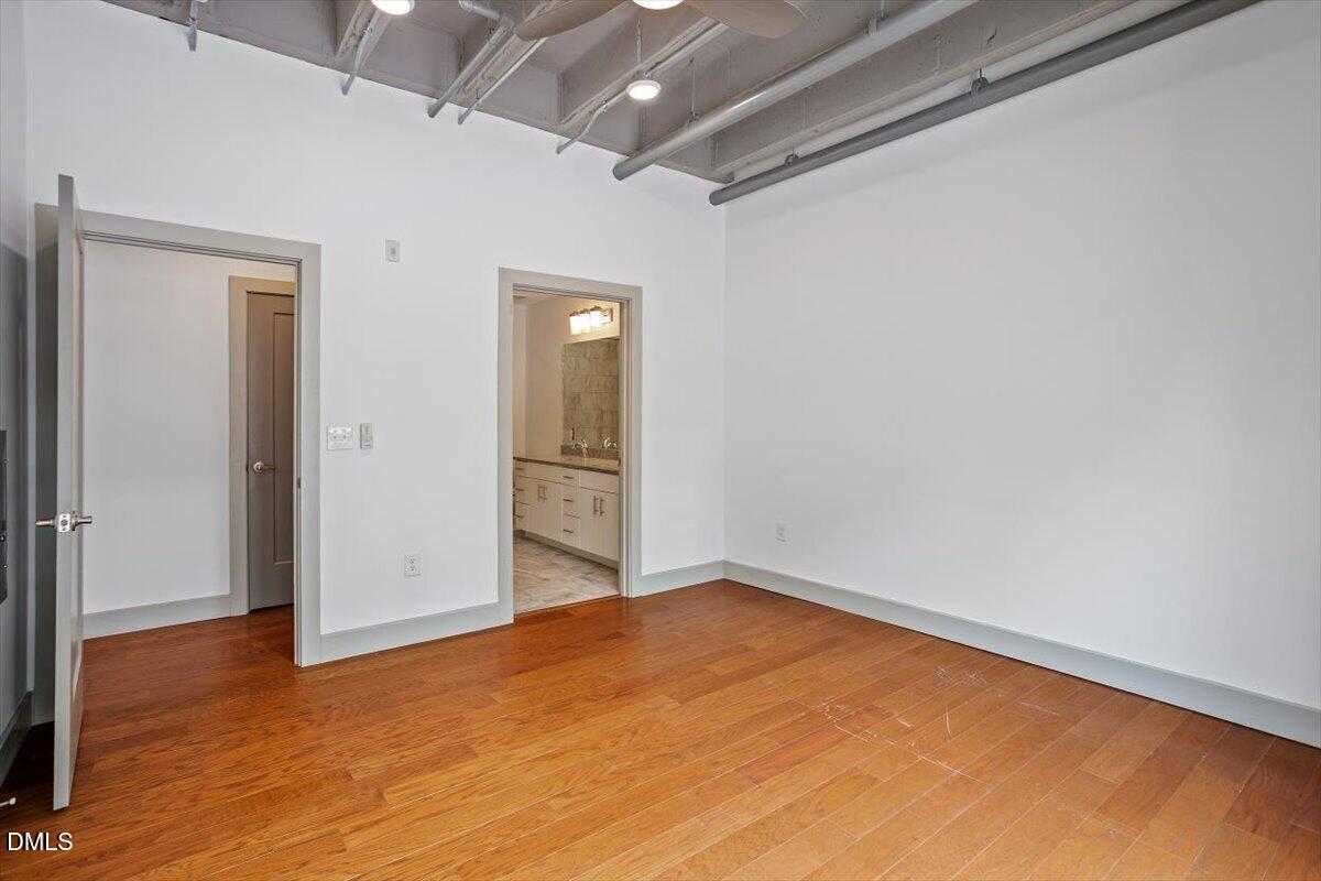 1300 St Marys Street, Unit 207 Raleigh, NC 27605 - Photo 9 of 31 a view of empty room with wooden floor