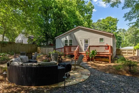 a view of backyard of house with seating space