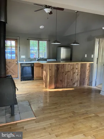 a view of kitchen with cabinets and window