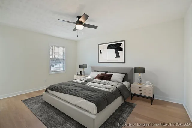an empty room with a window and ceiling fan