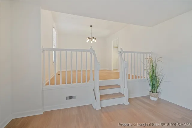 a view of a room with wooden floor and closet