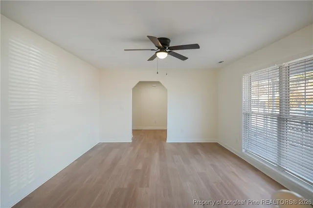 a view of a livingroom with a ceiling fan and window