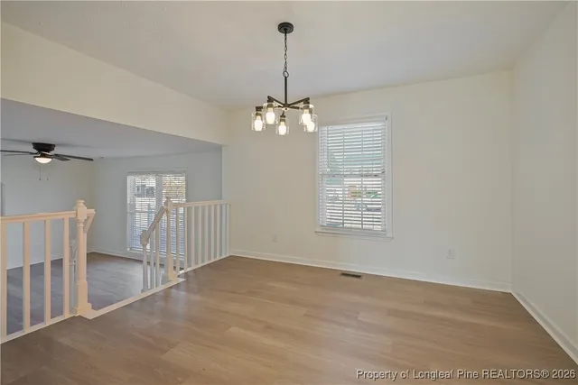 a kitchen with stainless steel appliances granite countertop white cabinets and window
