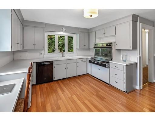 54 Sturtevant Road Quincy, MA 02169 - Photo 12 of 32 a kitchen with stainless steel appliances granite countertop a stove a sink dishwasher and a refrigerator