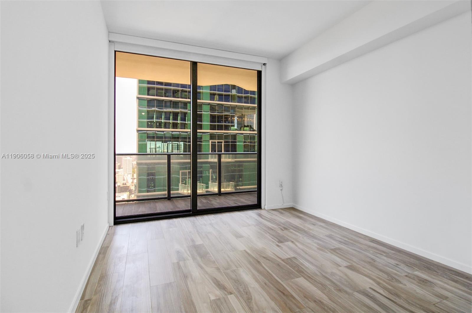 801 South Miami Avenue, Unit 4309 Miami, FL 33131 - Photo 22 of 34 a view of a room with wooden floor and a window