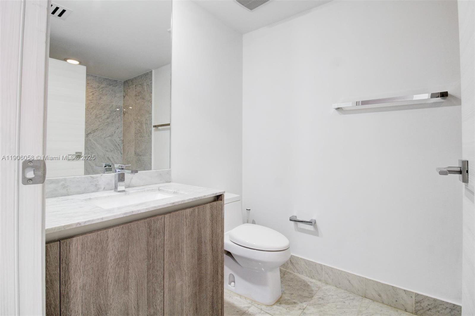 801 South Miami Avenue, Unit 4309 Miami, FL 33131 - Photo 23 of 34 a bathroom with a sink and a toilet