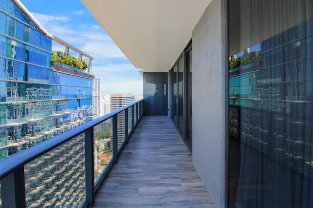 a view of balcony with wooden floor and potted plants