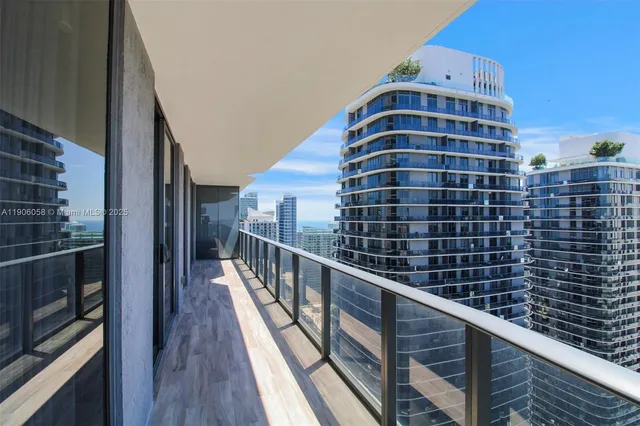 a view of a balcony with wooden floor and windows