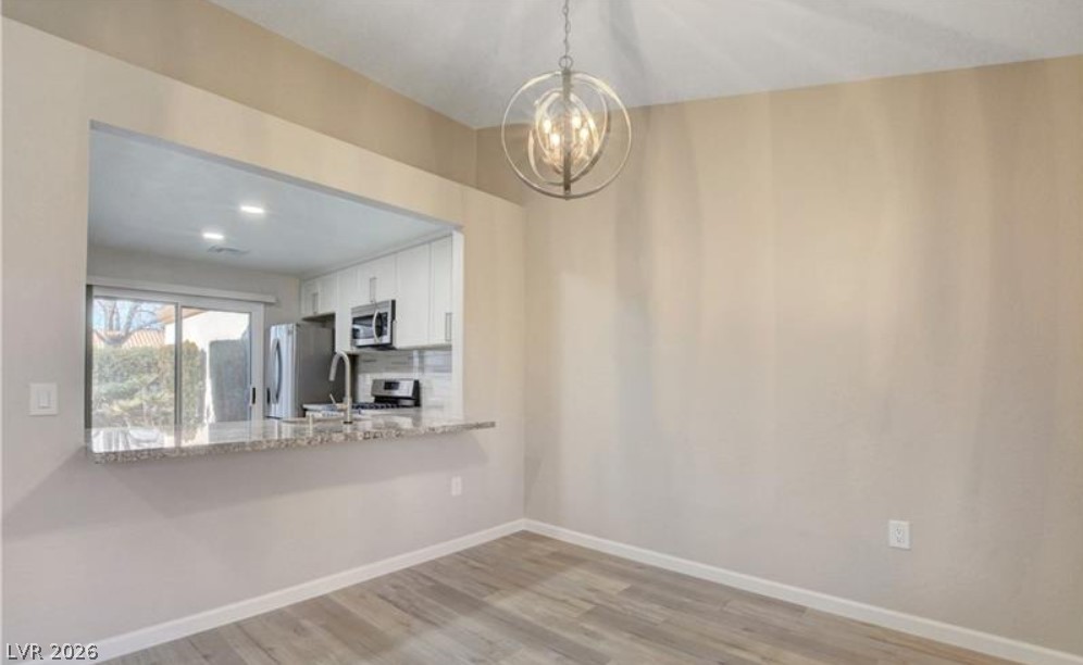 2716 Showcase Drive Las Vegas, NV 89134 - Photo 17 of 45 An open-concept dining area offers seamless flow to the adjacent kitchen, complete with a breakfast bar.
