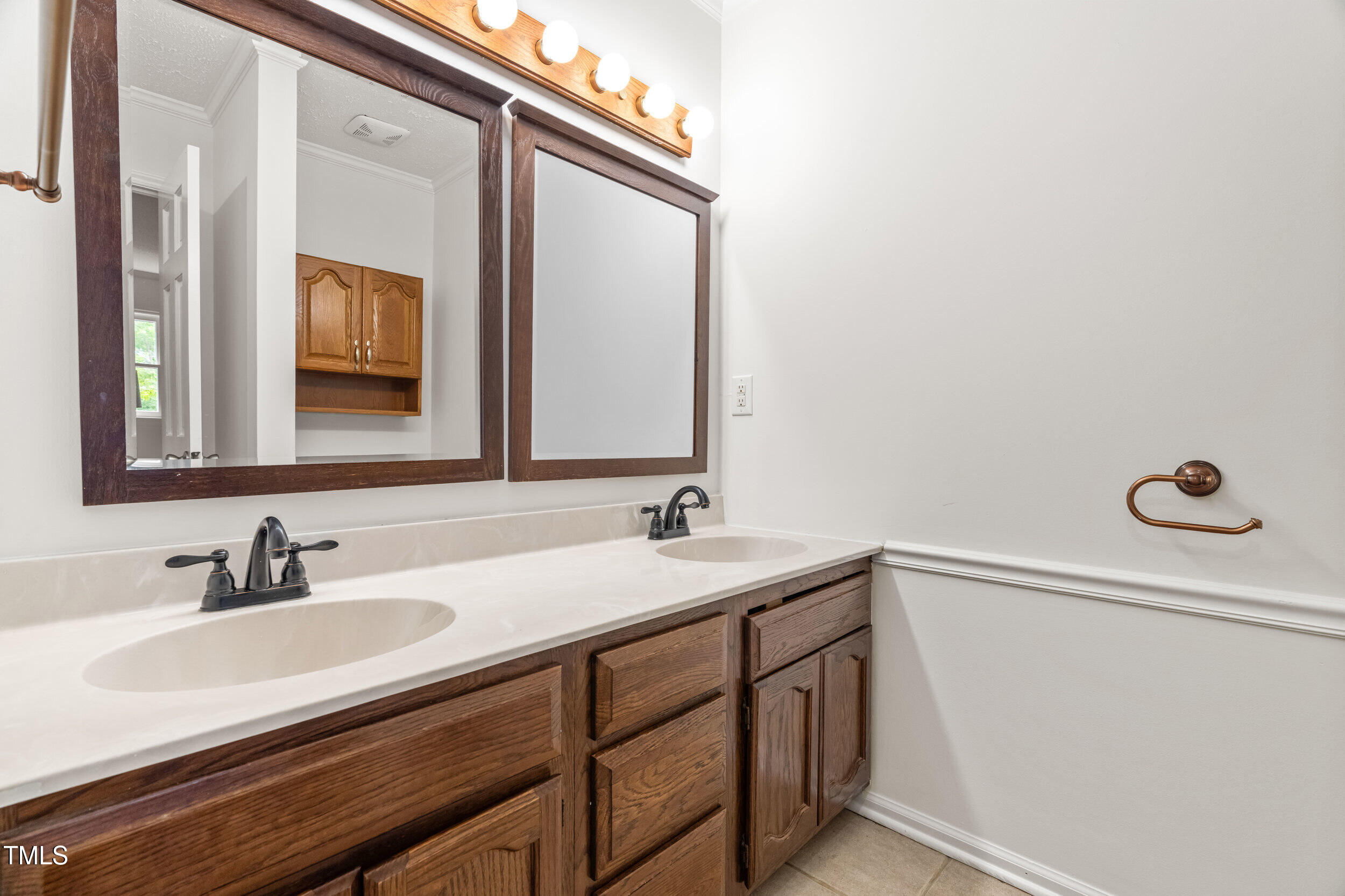 105 Firewood Circle Raleigh, NC 27607 - Photo 11 of 50 a bathroom with a sink and a mirror