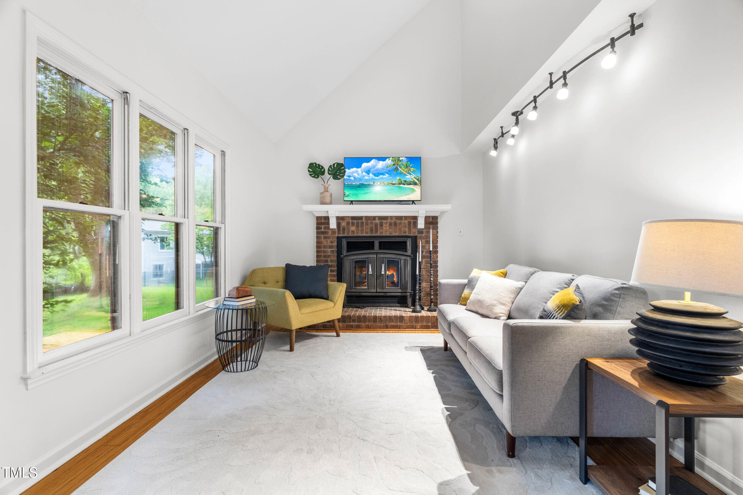 105 Firewood Circle Raleigh, NC 27607 - Photo 20 of 50 a living room with furniture a fireplace and a flat screen tv