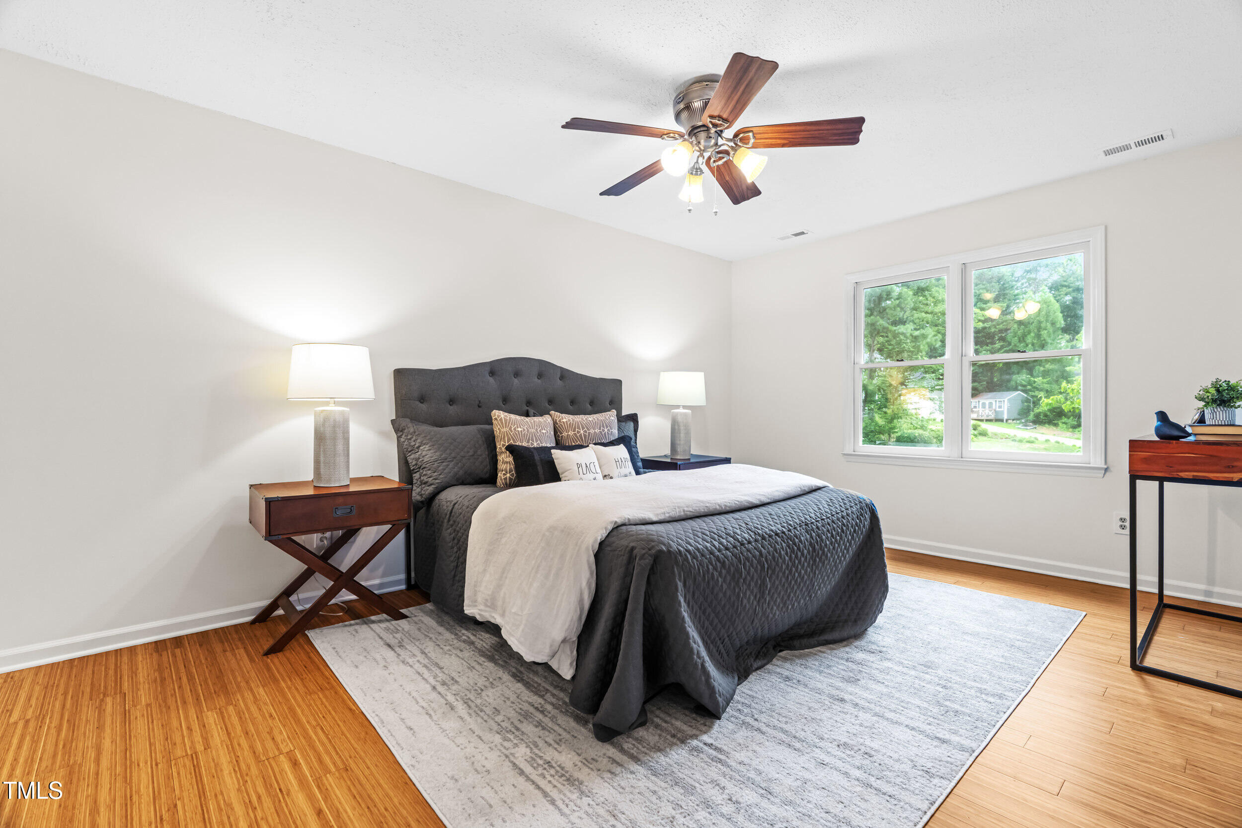105 Firewood Circle Raleigh, NC 27607 - Photo 26 of 50 a bedroom with a bed and wooden floor