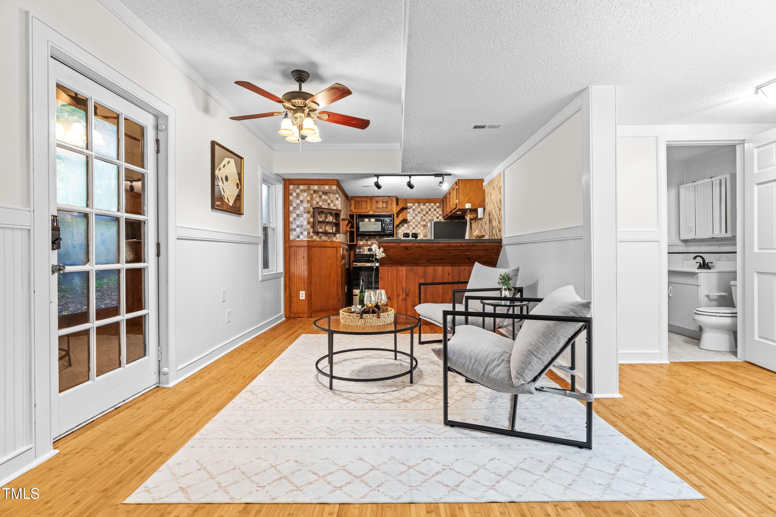 105 Firewood Circle Raleigh, NC 27607 - Photo 31 of 50 a living room with furniture a rug and a chandelier