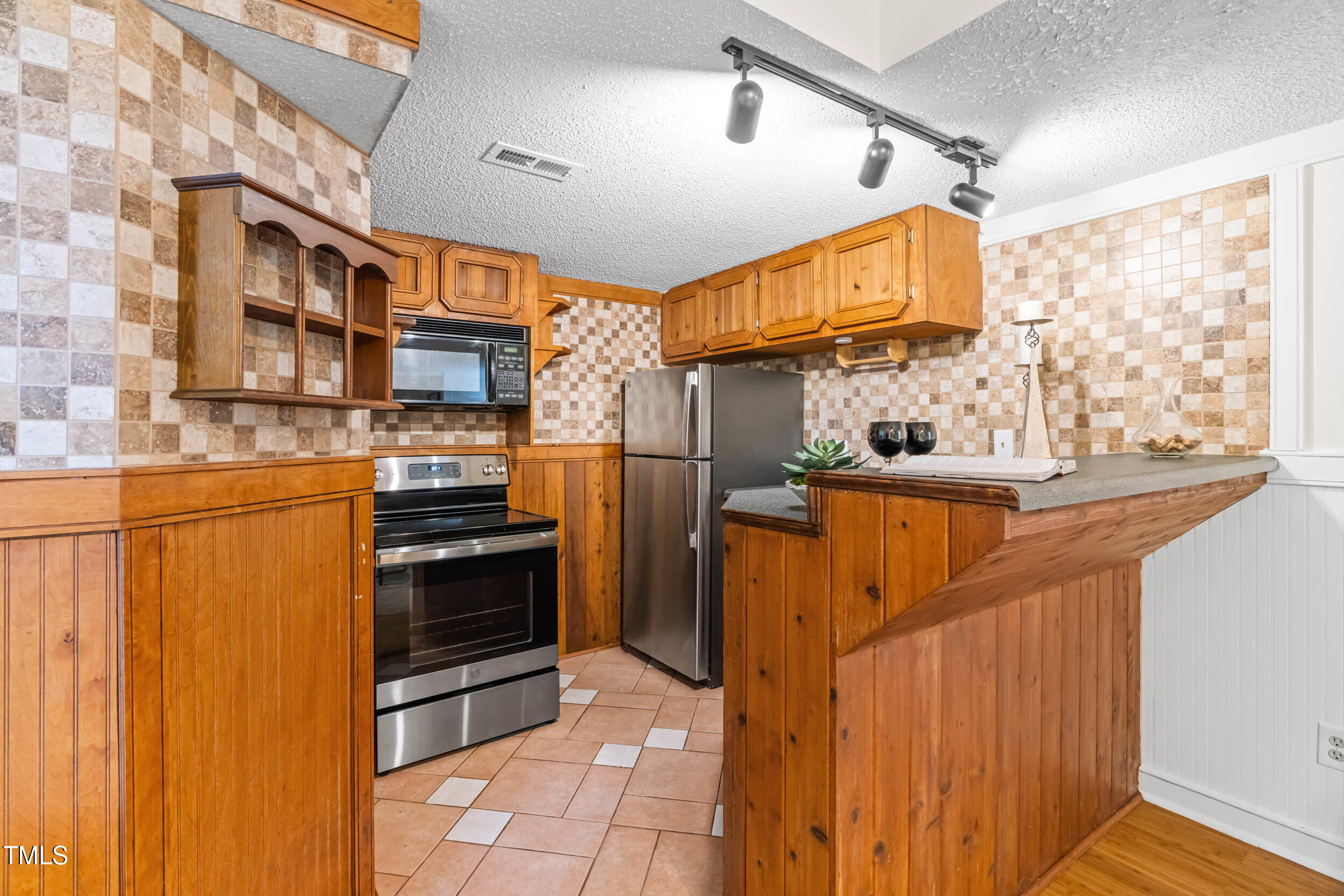 105 Firewood Circle Raleigh, NC 27607 - Photo 33 of 50 a kitchen with stainless steel appliances granite countertop a refrigerator and a stove top oven